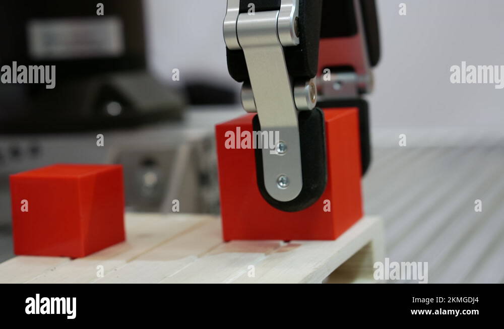 A robotic arm moves a cubeshaped part Stock Video Footage Alamy