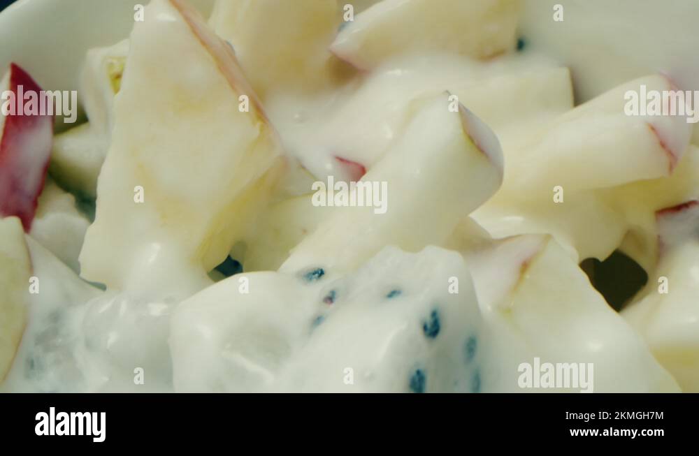 Yogurt with apple and pear sliced with dragon fruit and bananas in a