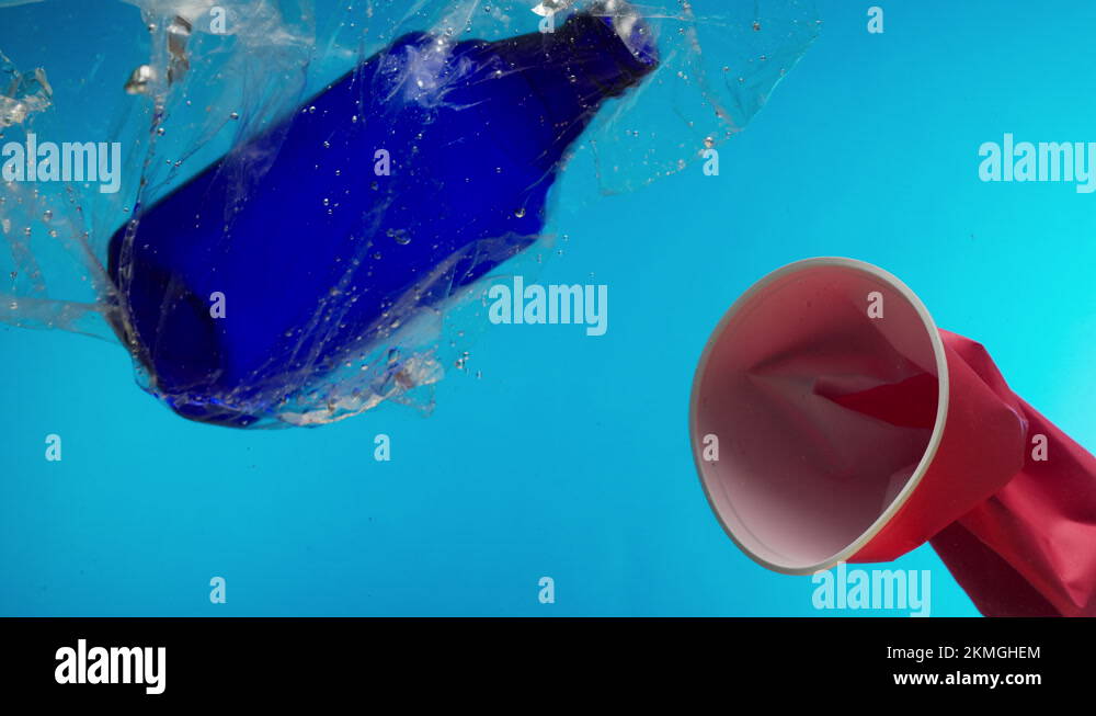 Plastic trash glasses and bottles in ocean, water pollution concept