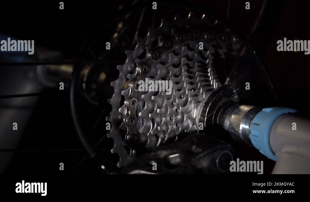 Closeup part of bike cogwheel is rotating with chain and changing gear