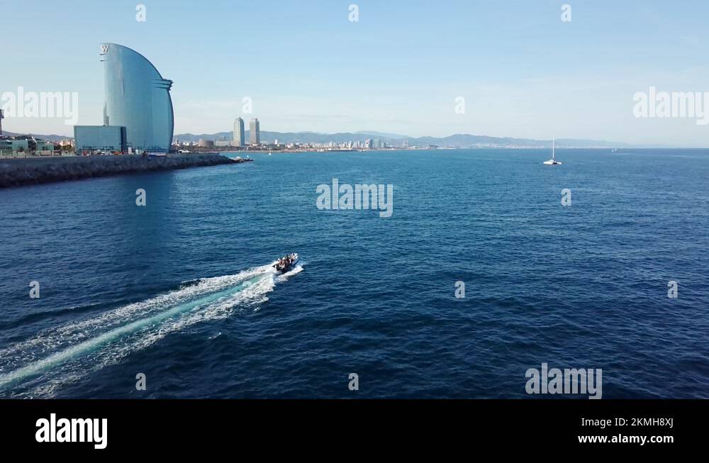 Boat Leaving Wake On Water With W Barcelona Hotel, Hotel Vela (Sail