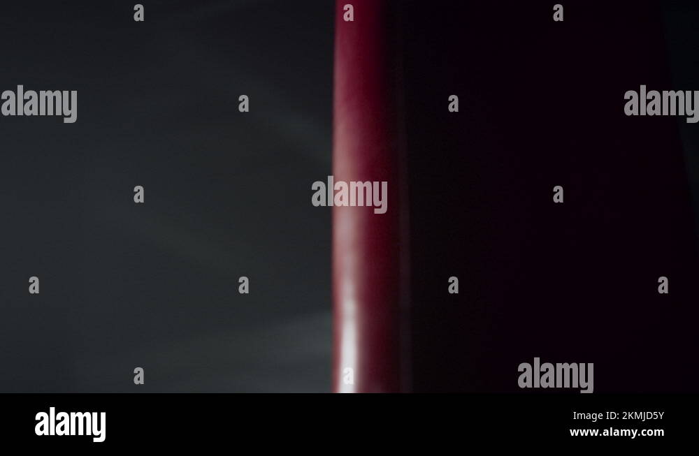 Fighter practicing kicks on punching bag in gym. Angry man boxing