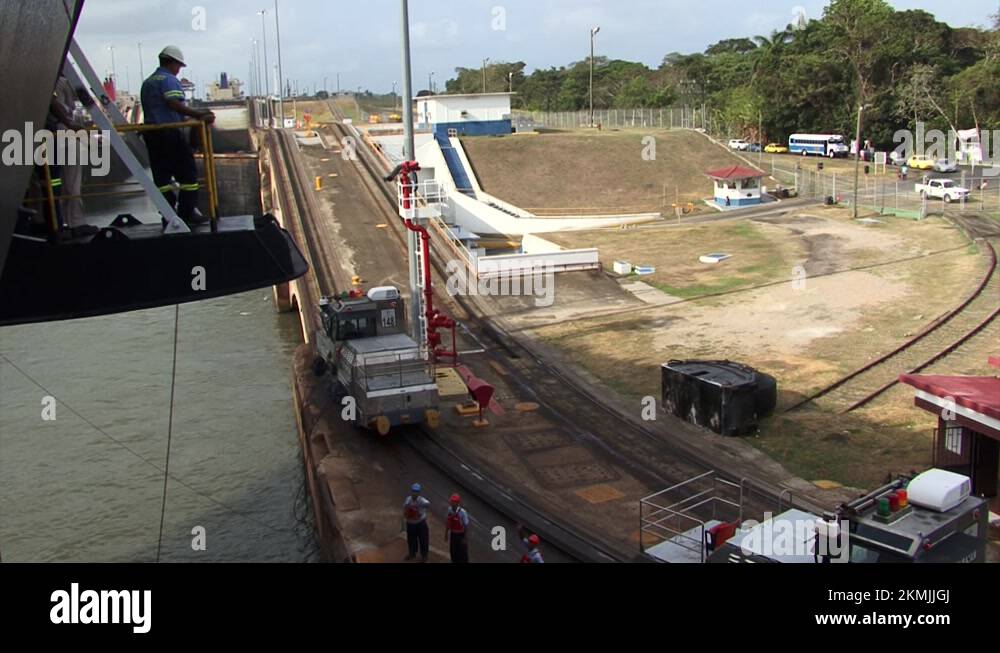 Panama Canal worker throwing the ship's mooring lines to the shore