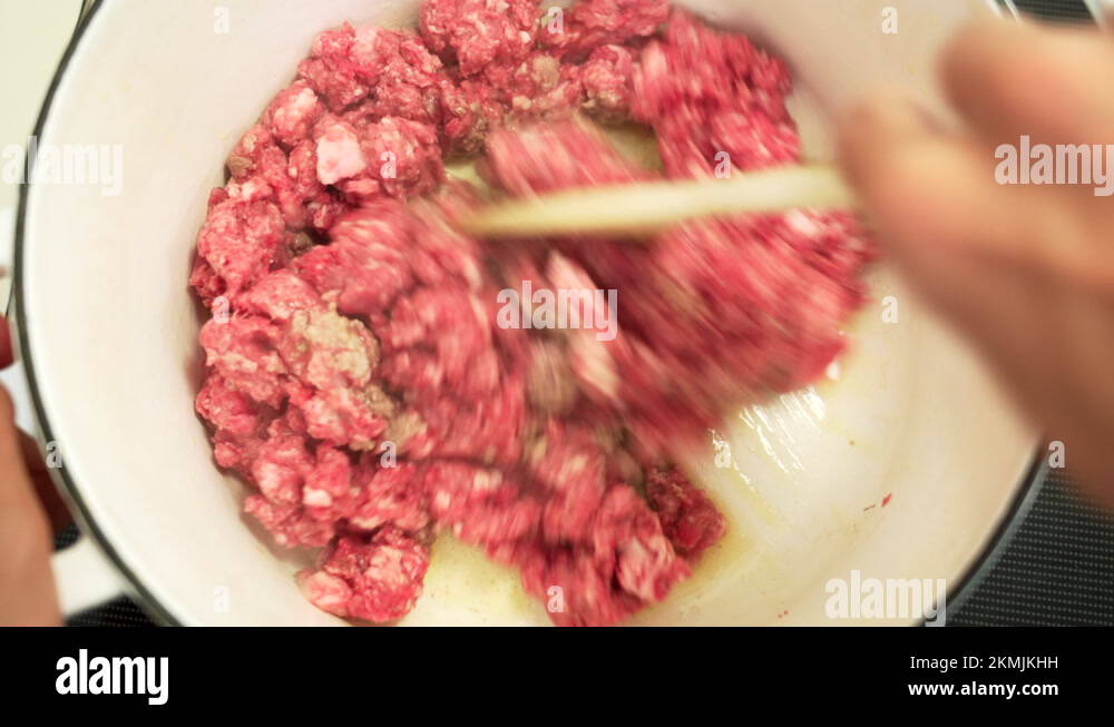 Cooking beef. The ground beef is browning in a cast iron pot (Top view and Stock Video Footage