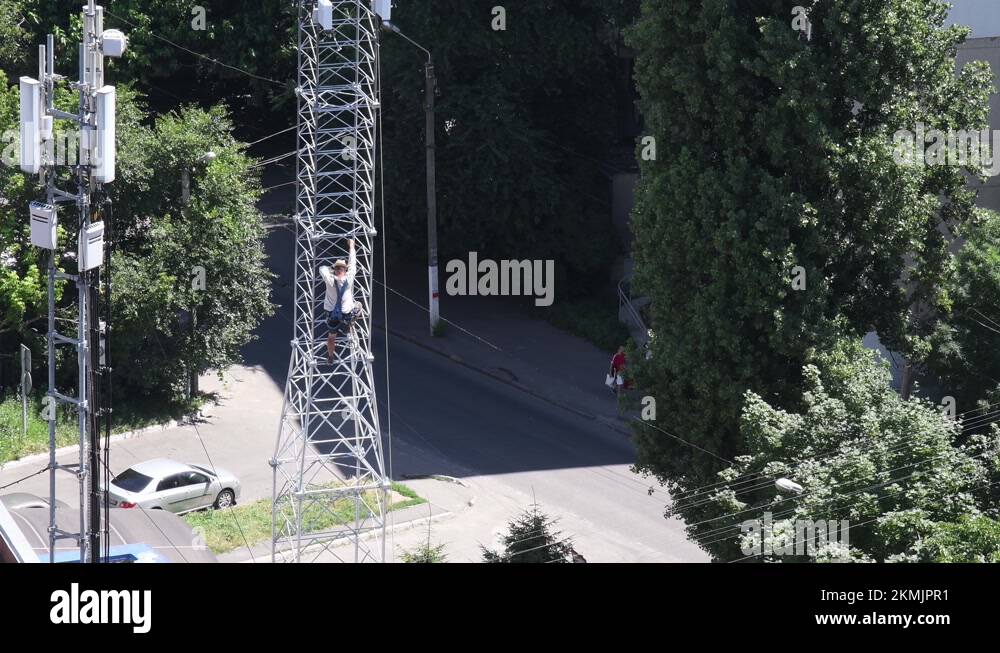 Mountaineer construction worker climb to top of communication tower