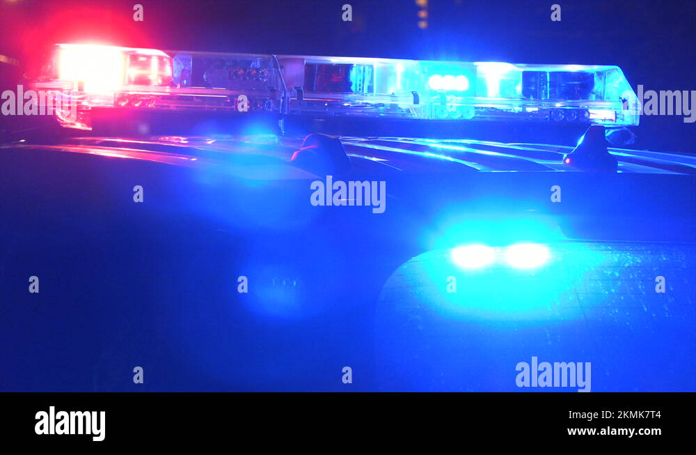 Multiple police cars at night with emergency lights flashing at crime