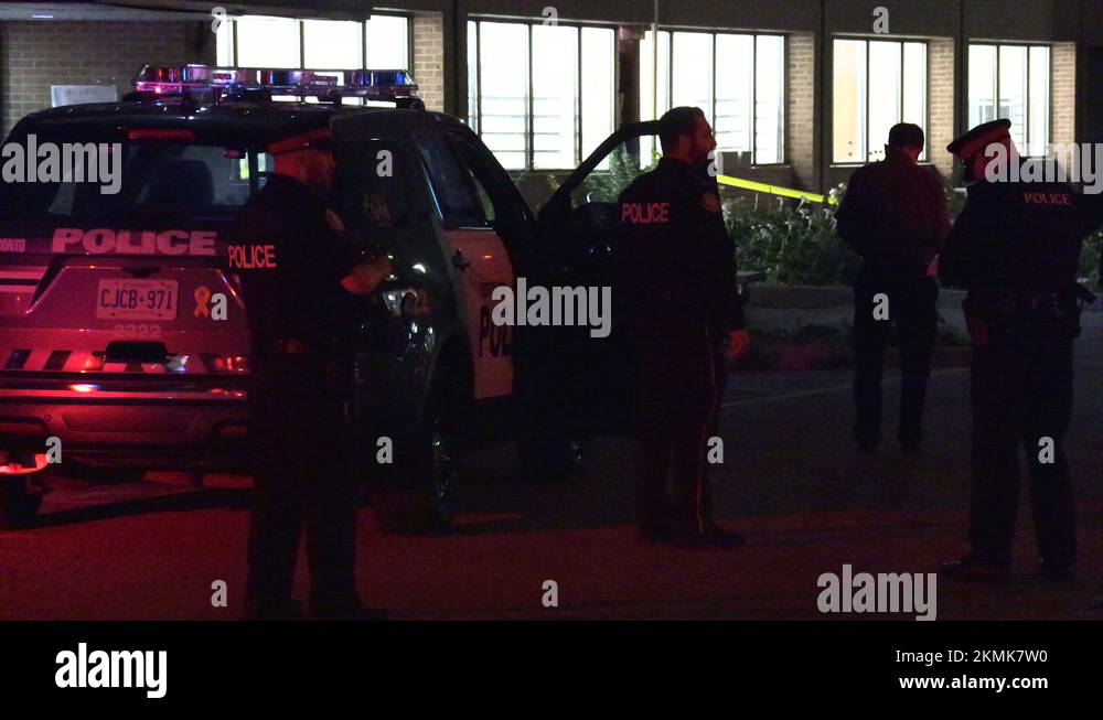 Multiple police cars at night with emergency lights flashing at crime