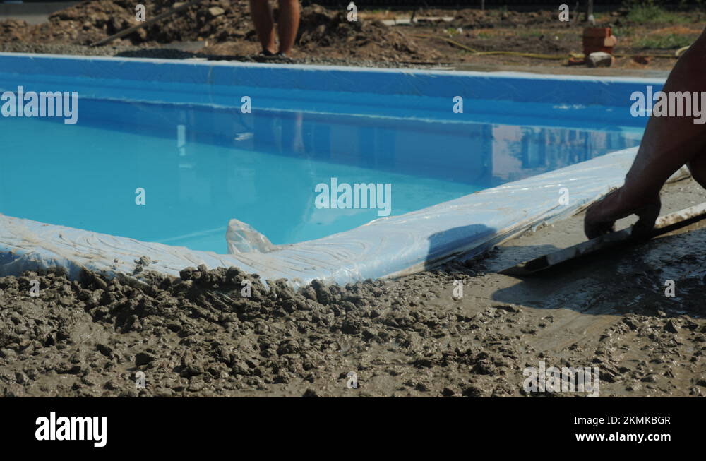 Builders pour concrete around the pool, do paving Stock Video Footage