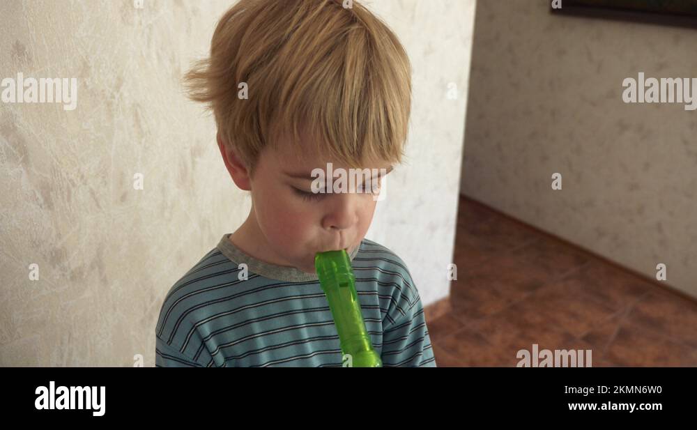 Cute Little Boy Tries to Play Flute. Happy Joyful Adorable Child Kid Smile 4K Stock Video