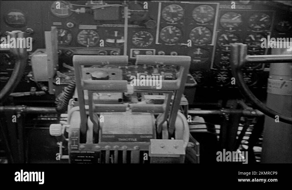 1940s: Inside cockpit of bomber plane, steering wheel moves. Bomber in