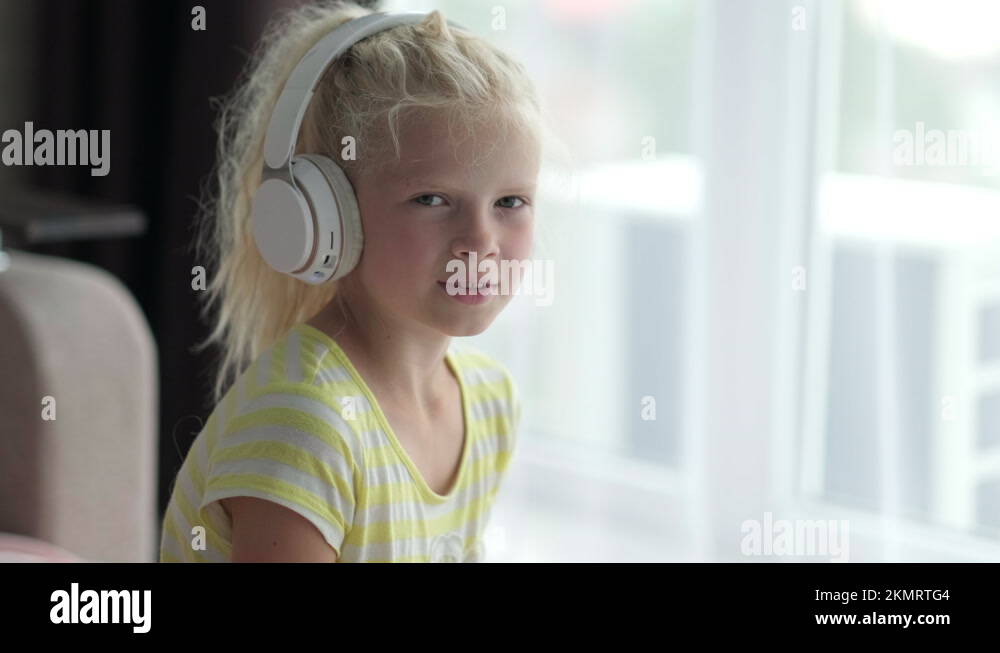 Portrait beautiful smiling girl in headphones. child listening enjoying