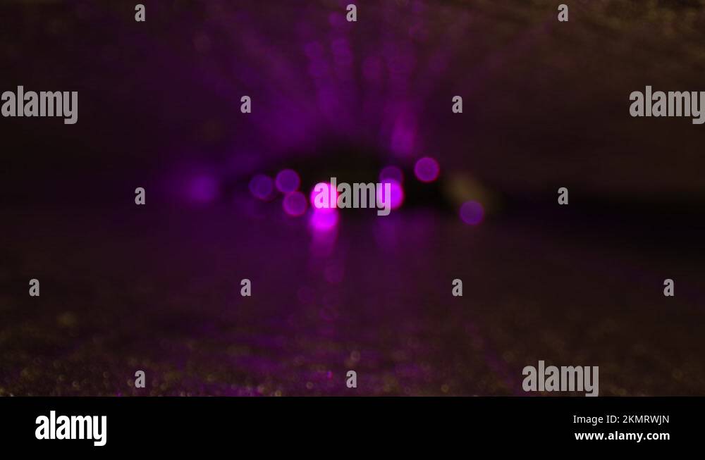 DEFOCUSED pulsating purple led lights reflecting off the top and bottom
