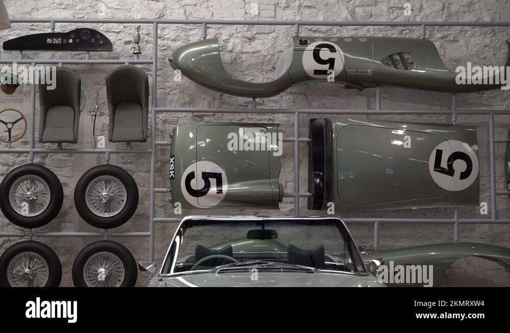 Vintage sport car parts on wall of modern garage, dolly forward view Stock Video Footage Alamy