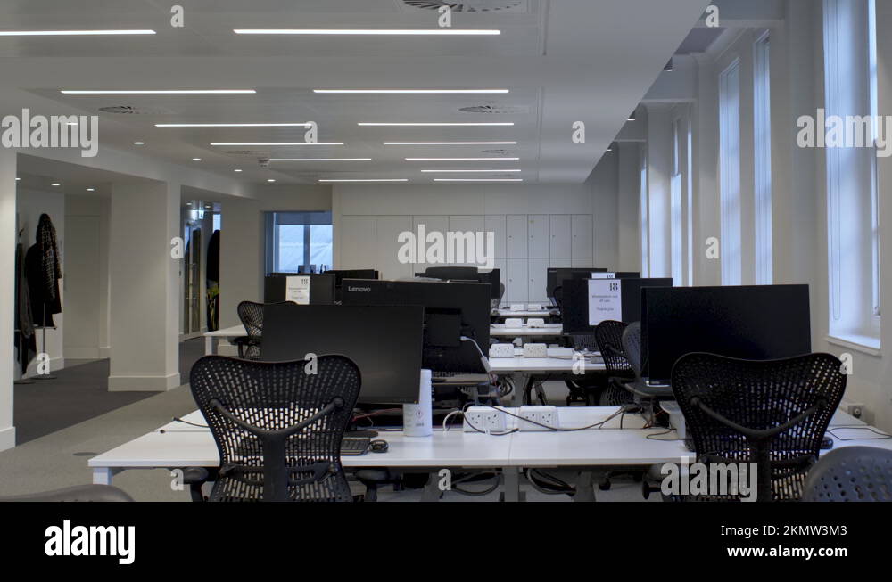 Empty Desks And Chairs In Open Plan Office Building In London. Slow