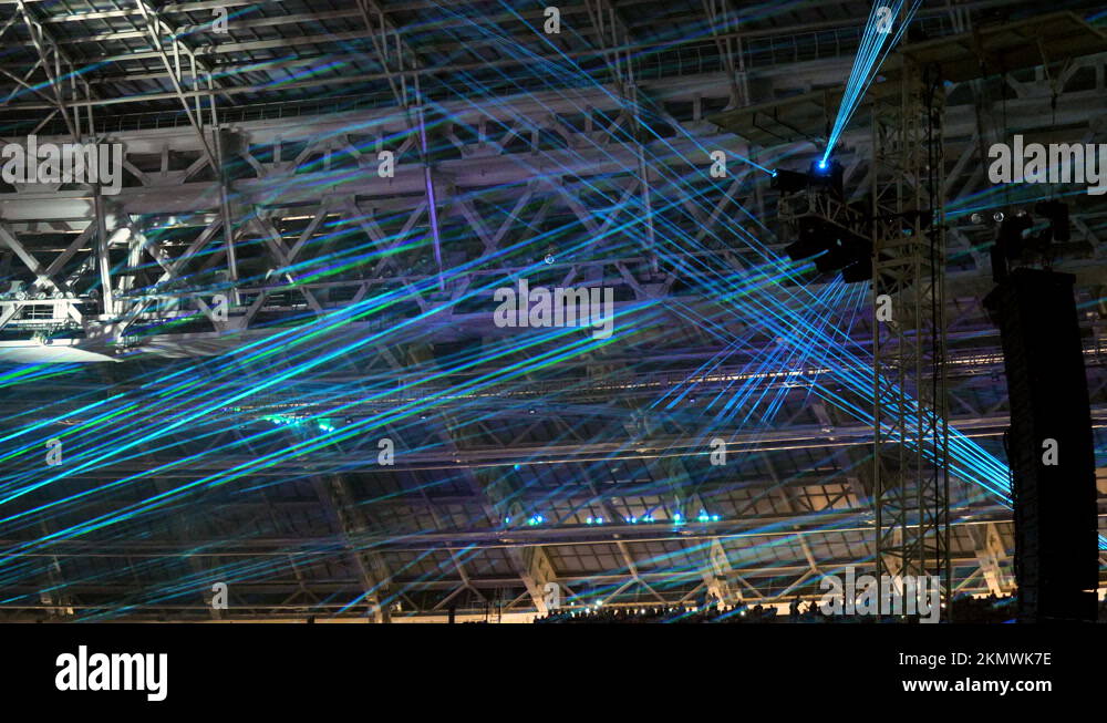 Crowd of fans standing in fan zone during rock or pop music concert. 4K