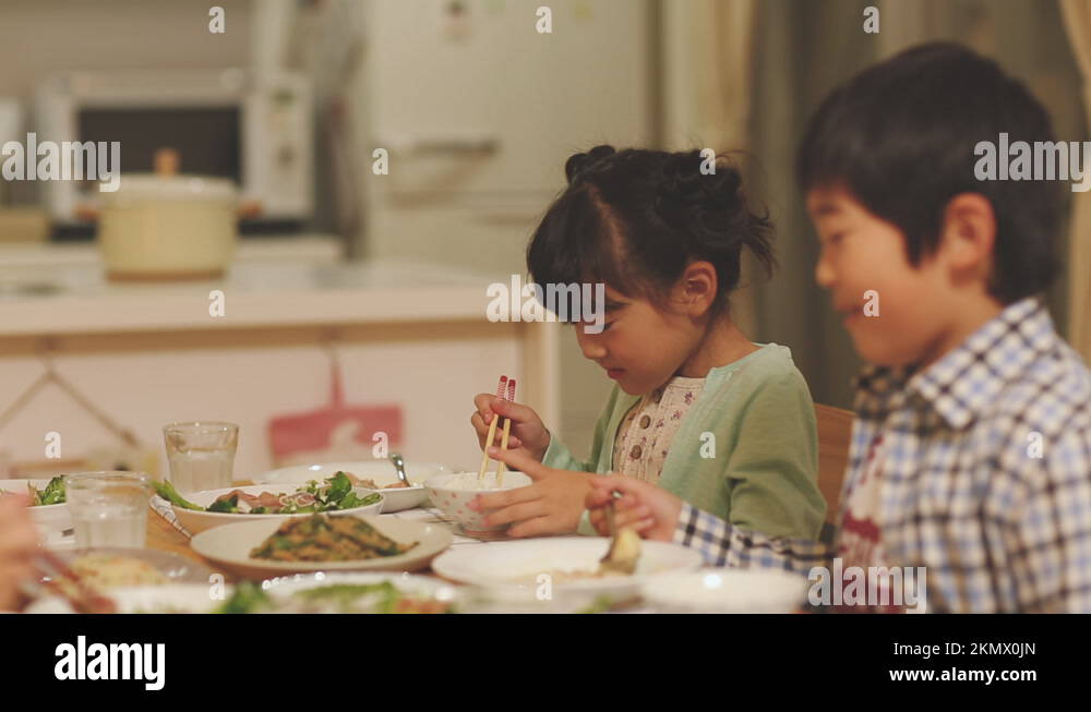 Brother and sister eating dinner Stock Video Footage Alamy