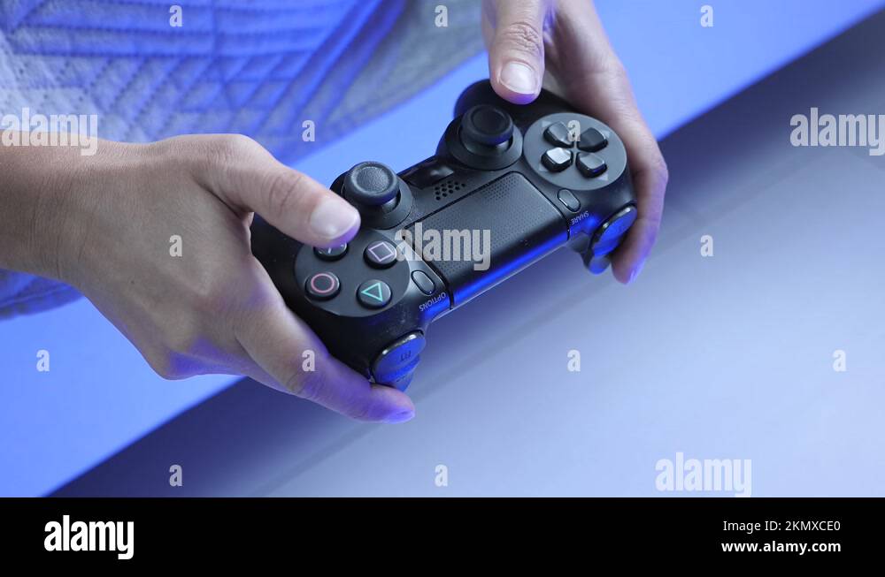 Playing video game with joystick. Hands tapping buttons on joypad video