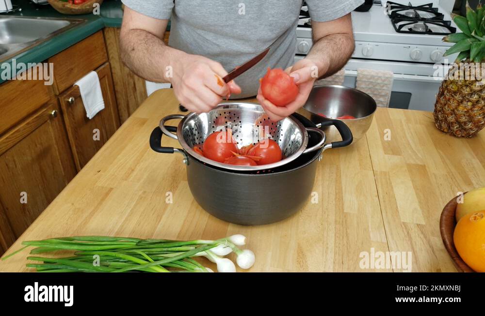 Tomatoes being skinned after hot water bath or blanching Stock Video