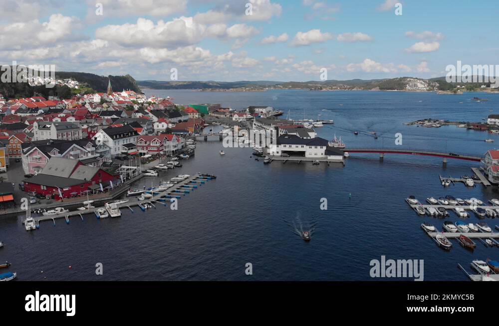 Slow aerial pan showing quaint coastal village and its marina ...