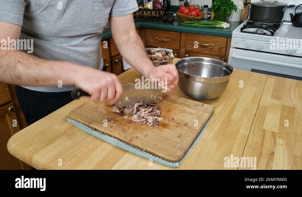 Time lapse of using chopping knife to mince cooked beef preparing meat