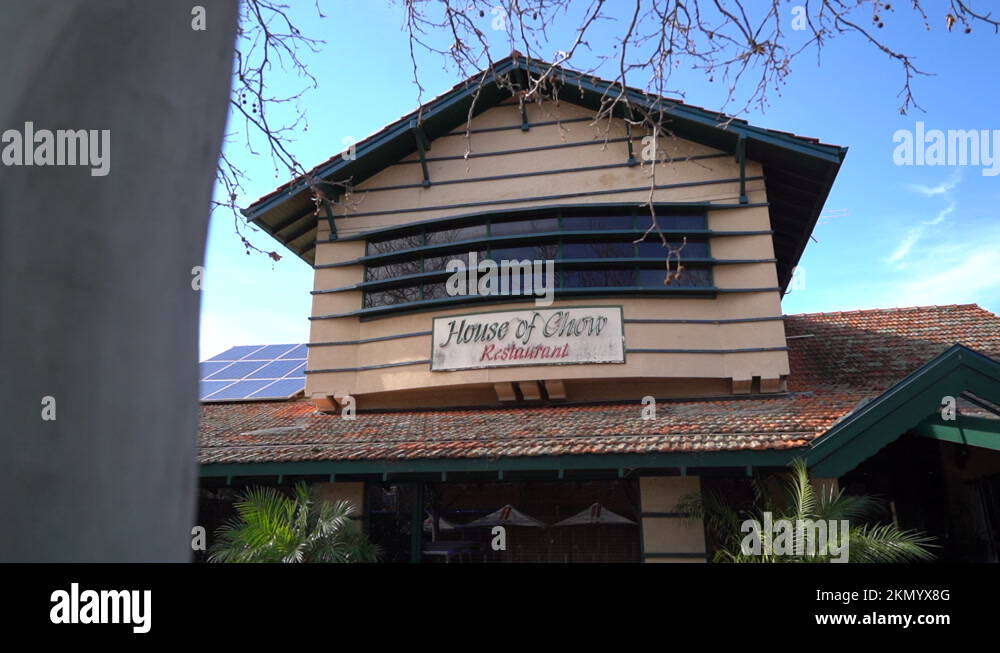 Restaurant called House of Chow signboard on building facade, dolly