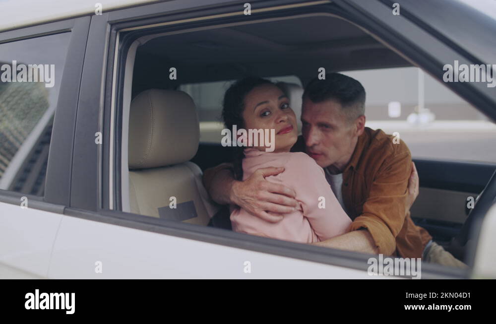 Lovers secretly hugging in the car, looking around, family cheating