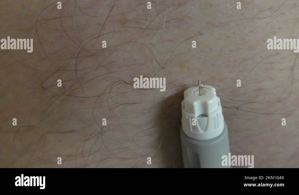 A man primes Ozempic syringe for lowering Hemoglobin A1C and weight