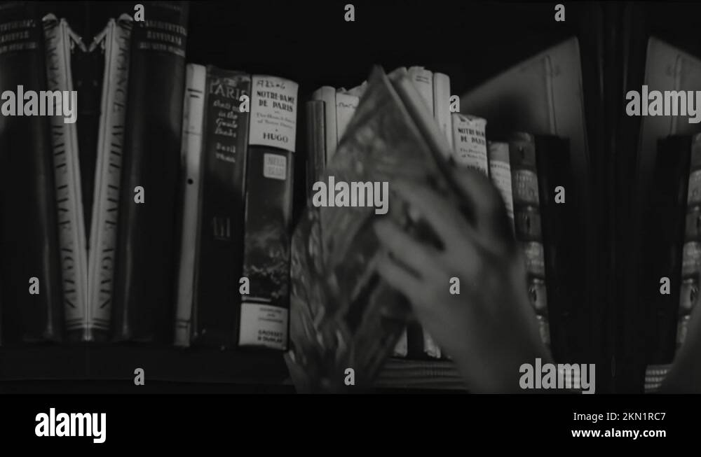 1940s Woman on pedestal. Hands pulling books off shelves. Hands