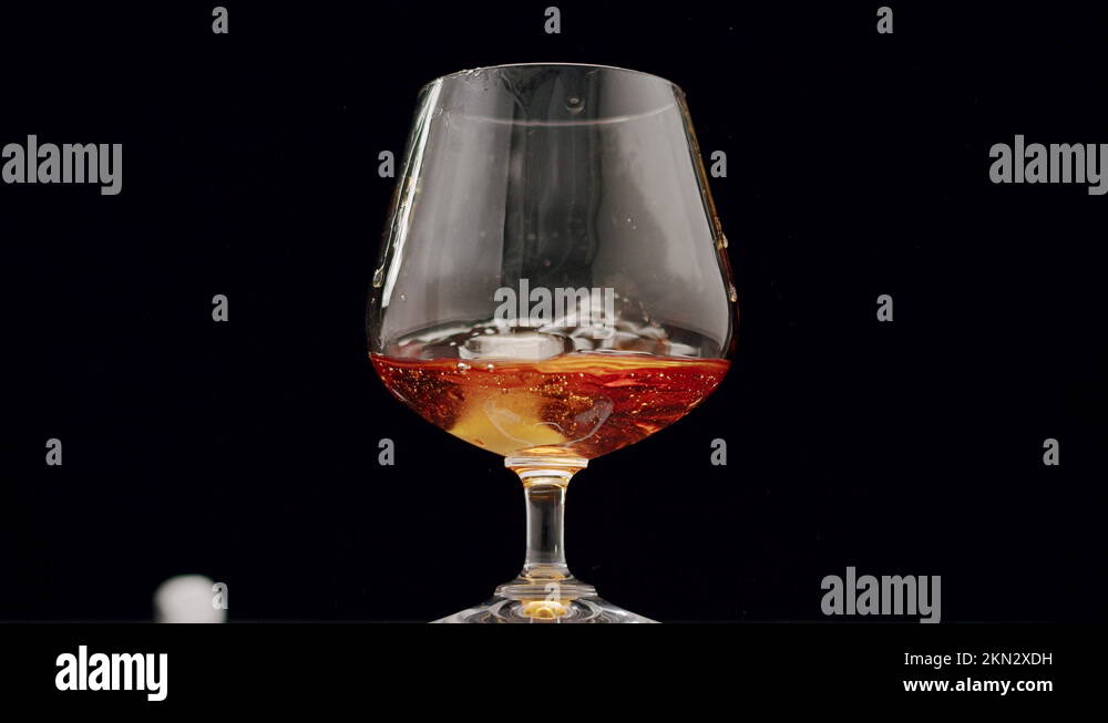 strong alcoholic drink Whiskey, Brandy, Cognac in glass with ice cubes