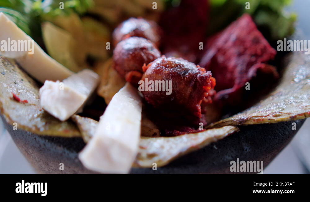 White cheese slices, lettuce, chorizo, and roasted nopales in Mexican