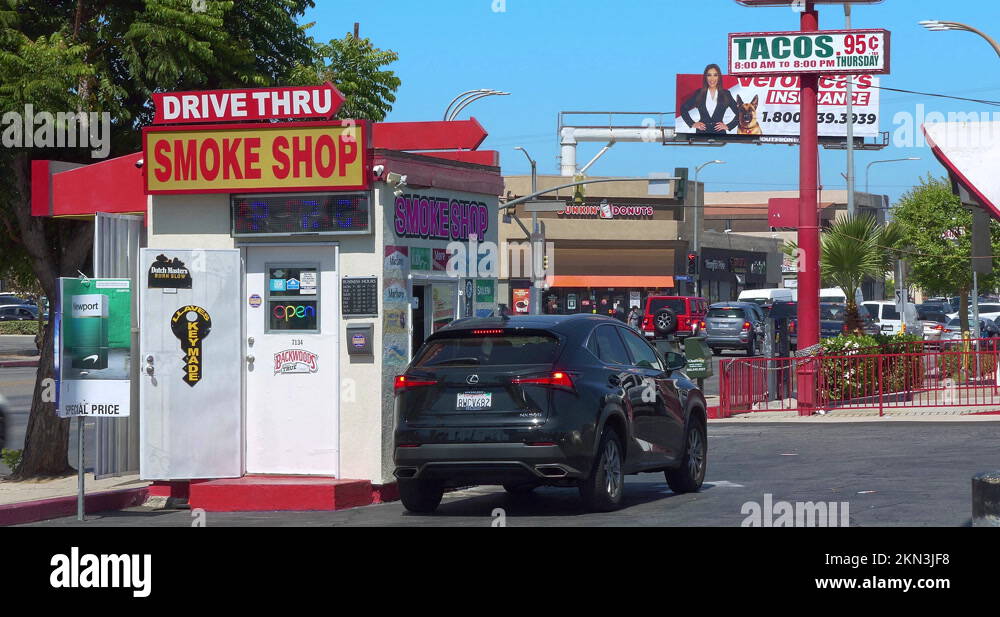 Customer in car buying cigarettes and tobacco products at drivethru