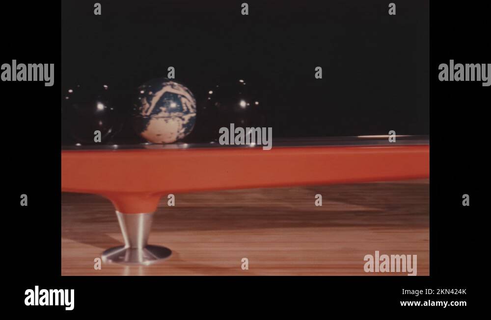 1960s: Bowling balls line up on ramp for use at beginning of lane Stock ...