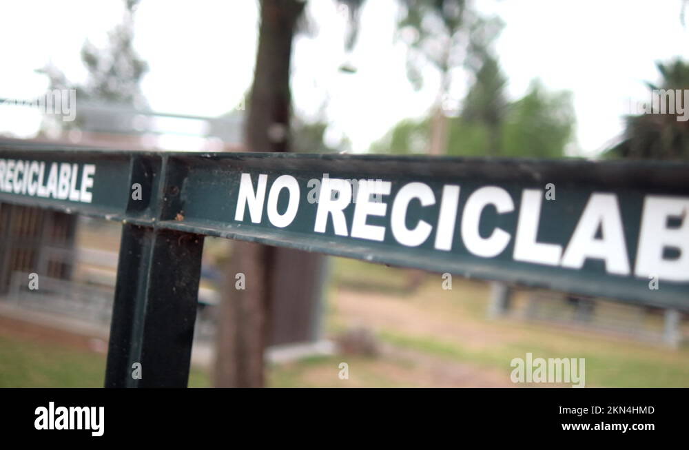 Spanish sign for recyclable and nonrecyclable trash with trees as