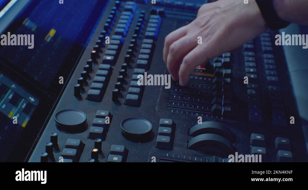 audio mixer in sound recording studio. video of hands turning and