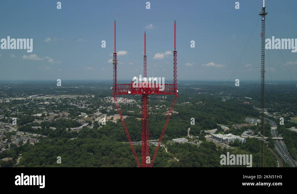 Two tall radio towers overlooking city Stock Video Footage Alamy