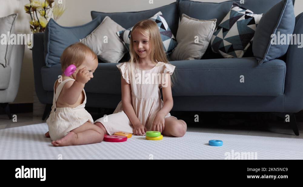 Two cute little caucasian children siblings playing together with