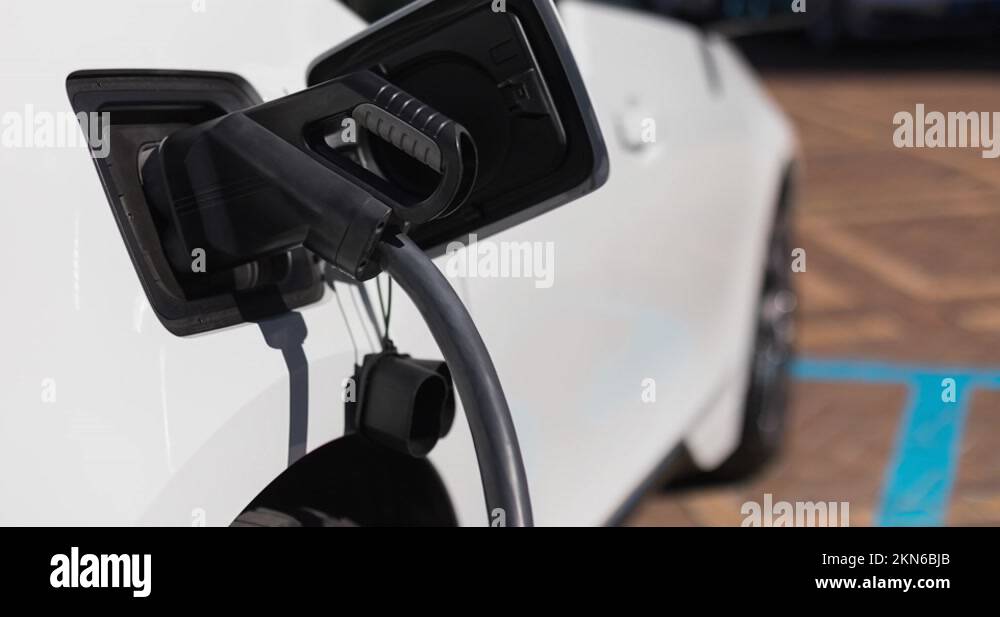 Electric car charging at electric vehicle charging station Stock Video