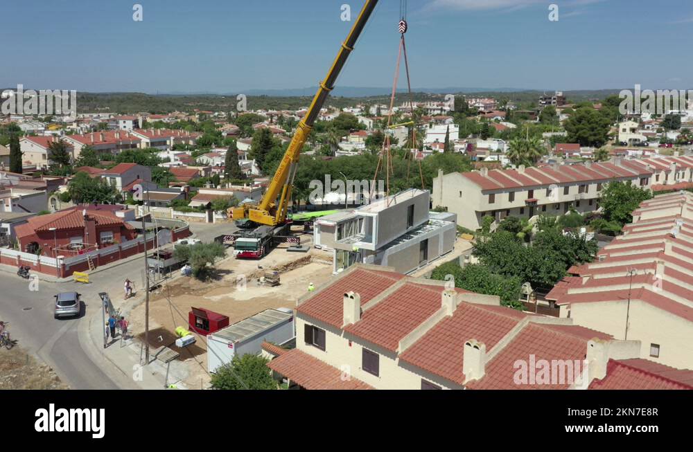 New estate being built and a large crane lifting modular homes into