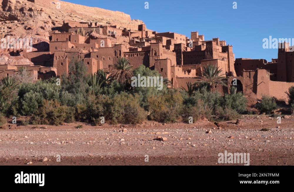 Camera pull back and reveal ancient mud house and palace with tower