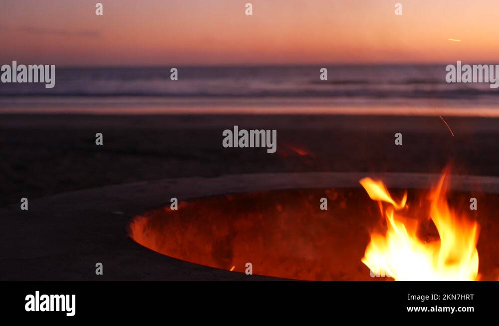 Campfire pit in California USA. Camp fire on twilight ocean beach