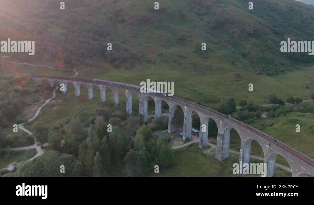 Drone Panning Above Glenfinnan Viaduct Scenic Railway Track With Large