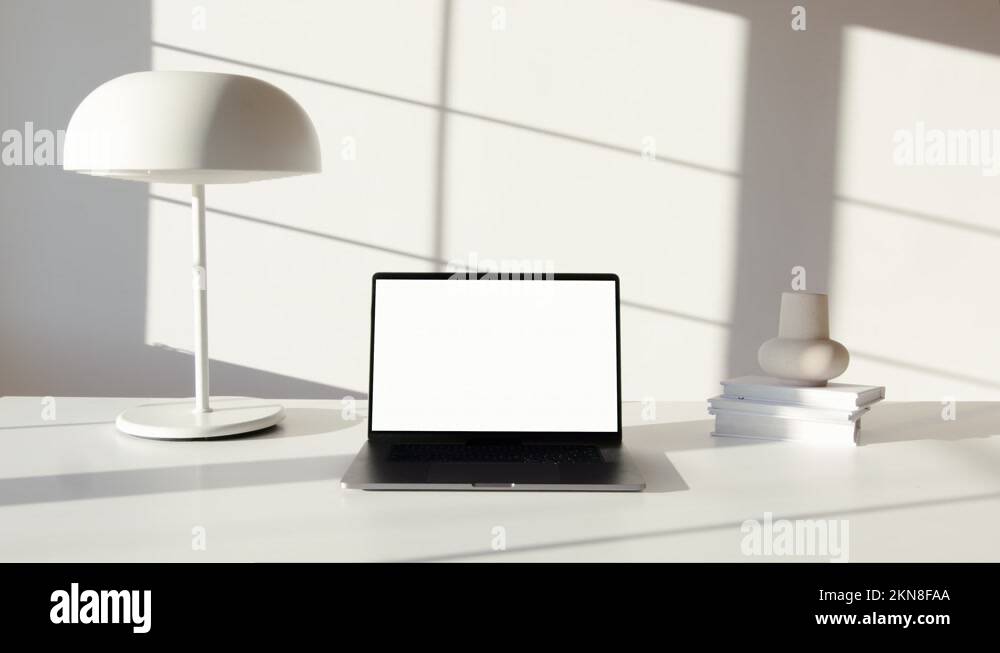 Camera zooming in on a laptop which is switched on and placed on a