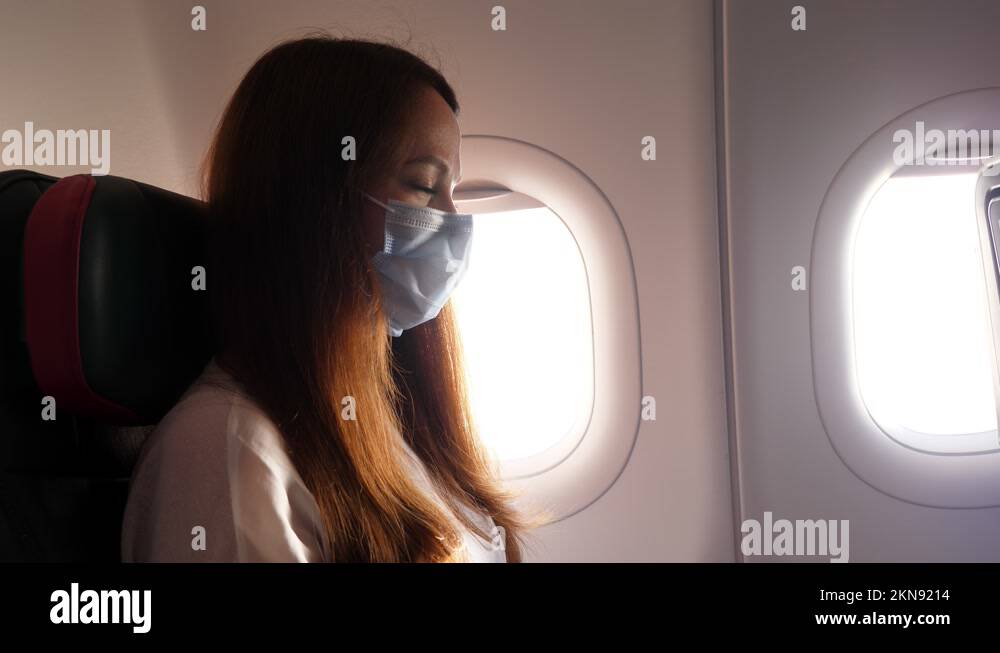 Passenger woman wear face mask during flight, new normal caused by
