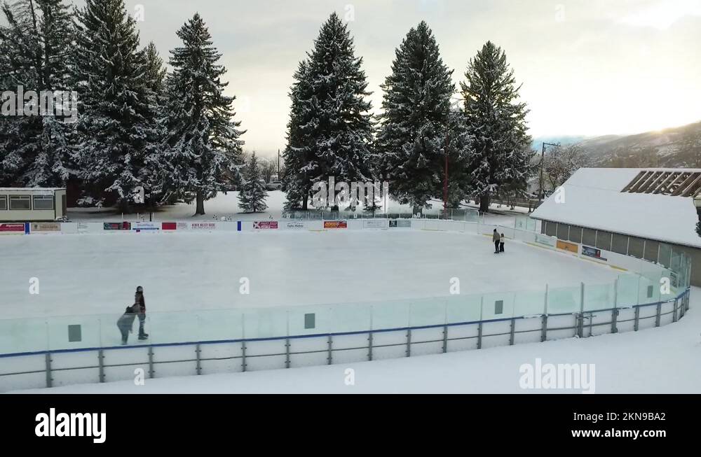 Ice Rink Full View Slow motion aerial pan and zooming out shot of a scenic ice rink in the ...