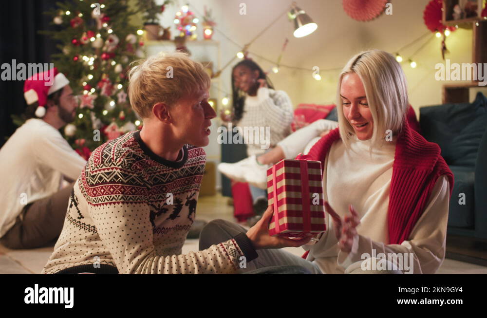 Man giving present to his girlfriend and hugging close-up. Young people ...
