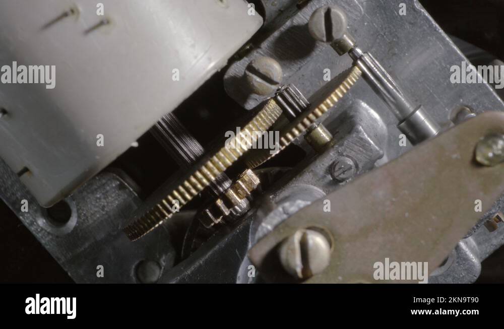 Rotating gears inside the mechanism of an old music box. Closeup Stock