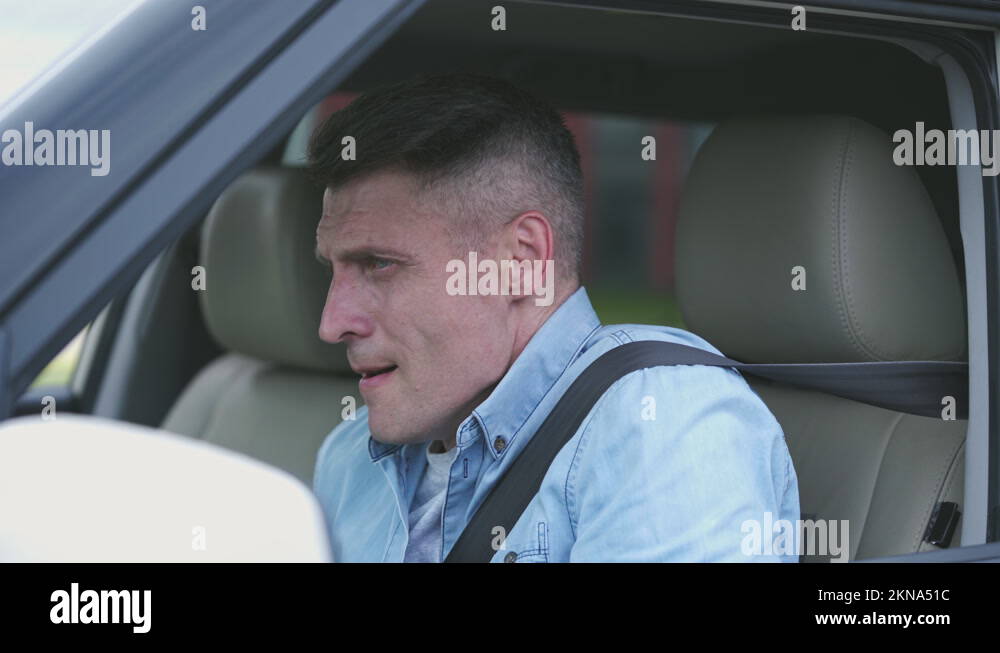 Anxious man driver feeling cramps and unbearable abdominal pain