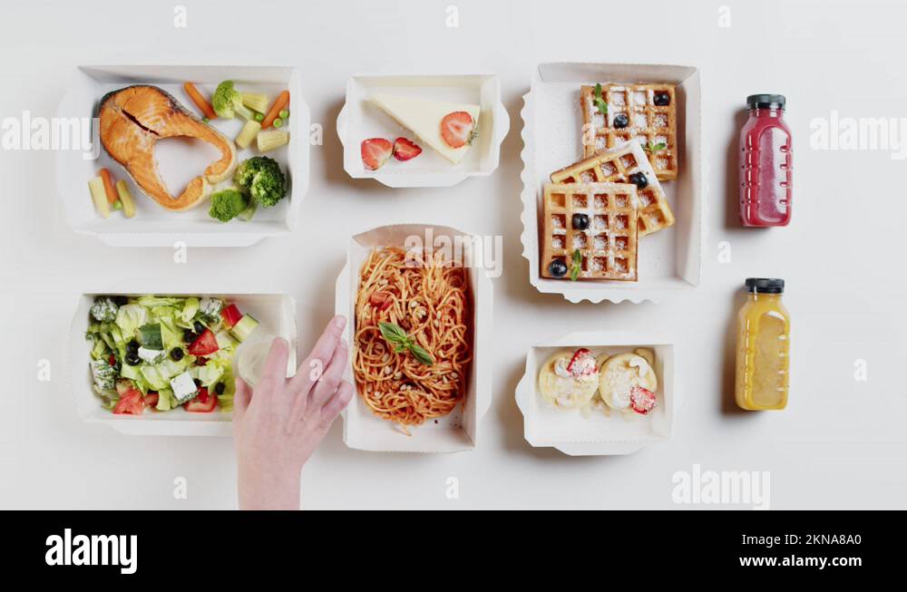 Food delivery top view. Lunch boxes with cooked salmon fish, spaghetti