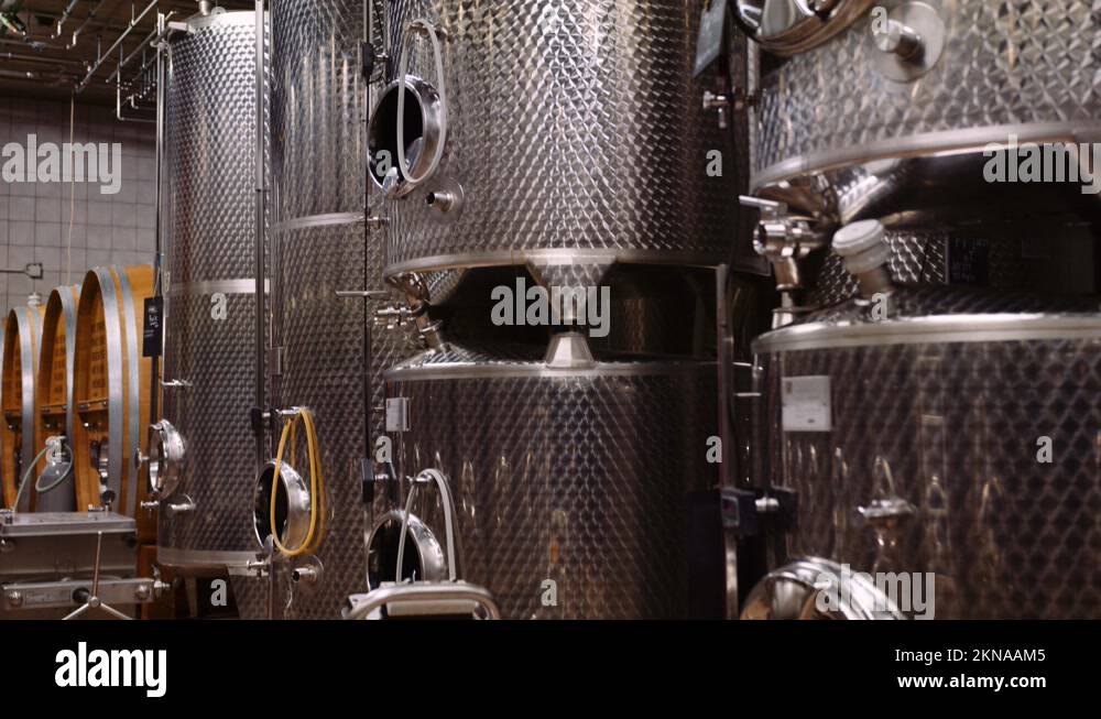 Stainless steel wine fermentation tanks in modern winecellar; tiltup Stock Video Footage Alamy