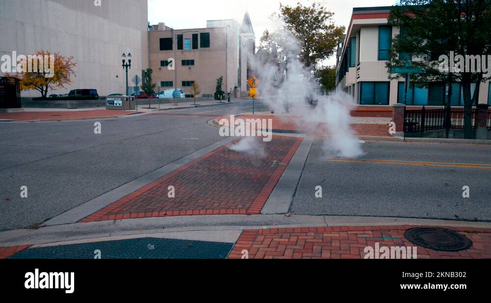Steam rising from below a city street in Lansing, Michigan Stock Video ...